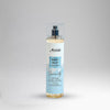 Body mist bottle with a label on a gray background