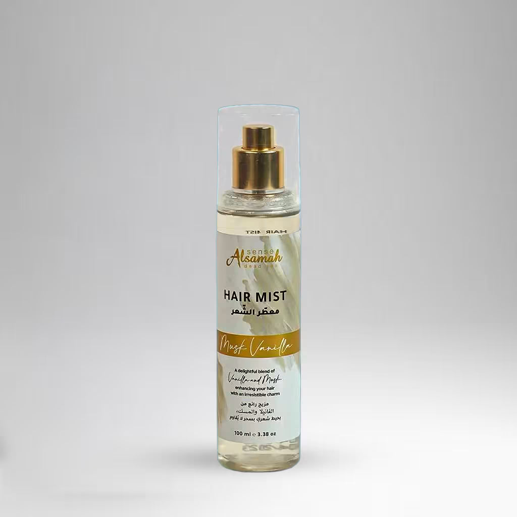 Hair mist bottle with gold cap on a gray background