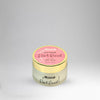 Perfume jar with pink label on a gray background