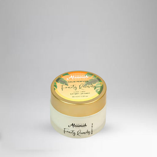 Solid perfume container with gold lid and white body on a light gray background